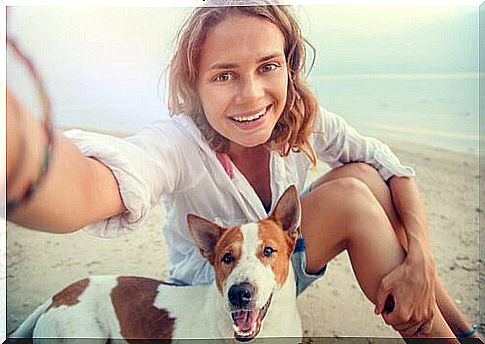 dog and mistress on the beach 