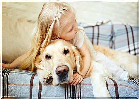 little girl with dog on the sofa