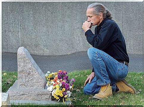 Man kneeling on animal grave 